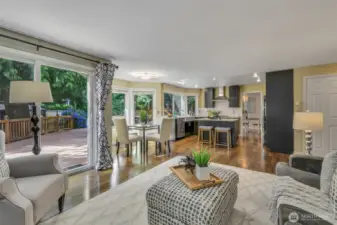 The open-concept layout connects the kitchen, dining nook, and family room, creating a spacious and fluid environment perfect for everyday comfort and entertaining.