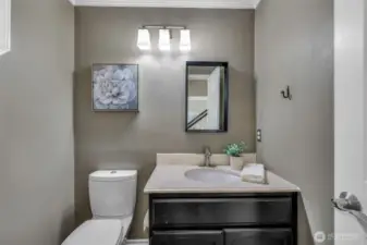 The main floor powder bath has been tastefully updated with modern fixtures and cabinetry, providing a stylish and convenient space for guests.