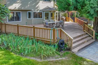 This view showcases the home's ideal indoor-outdoor connection, with the large deck easily accessed from main living areas and thoughtfully designed for gatherings and daily living alike.