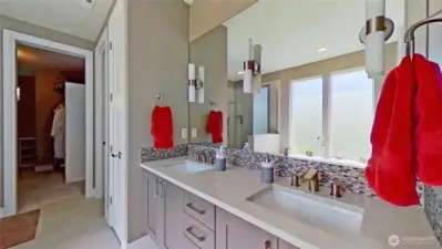 Primary bathroom with dual vanity and large walk-in closet