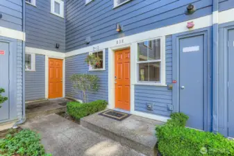 View of the back door via the courtyard. Behind the couryard is the parking lot, this unit comes with Space#16. There is also an outdoor storage closet.