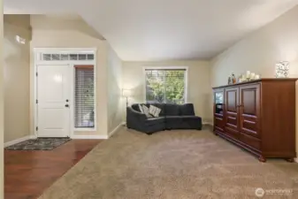 Open, vaulted ceiling entry with living room open to dining room
