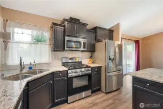 You'll find it all here; gleaming stainless-steel appliances, a gas (propane) range, granite counter-tops and a well laid-out kitchen for the cooking afficionado. The lower cabinetry features pull-out shelves for your convenience and cooking pleasure! All with an adjacent Butler's Pantry, and light and bright thanks to abundant windows and easy access to the oversize covered deck.