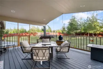 What a paradise inside and out! Here's a delightful place to relax with a cup of coffee or your favorite beverage and feel the breeze and listen to the sounds of nature. And a bit of rain will never faze you under cover on this spacious deck. Fire up the grill year-round!