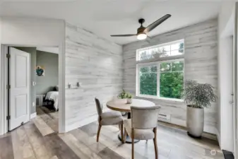 Cozy dining area with ceiling fan and accent walls.