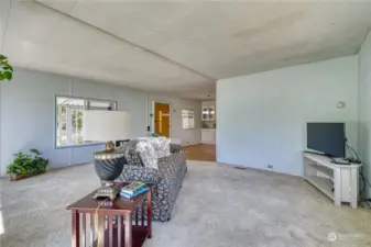 Large open living room features newer carpet