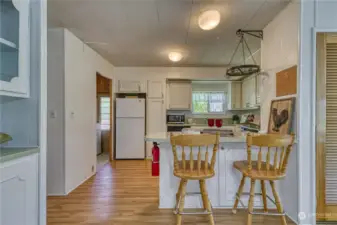 Cheerful kitchen is bright and offers an eating bar - all appliances included