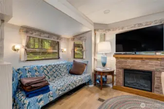 Brand new futon, big screen television and electric fireplace make for a cozy living room