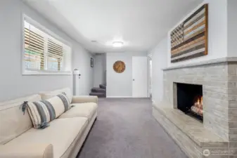 Lower-level family room with fireplace.
