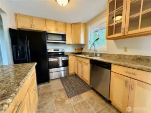 Updated Kitchen with shaker cabinets, stone counters and large sink.  New appliances.