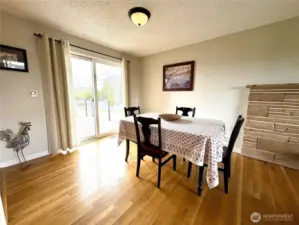Wood floors gleam in the dining room and slider out to the deck