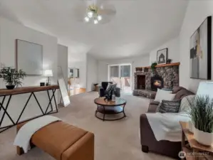 Living room next to kitchen and dining room and leading to large deck.