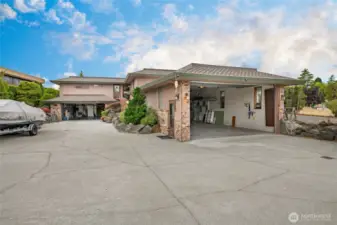 The the 1004 square foot garage shop on the right and the 856 sq. ft. garage & workshop on the left. The homesite itself has terrific parking and room for RV and Boats.