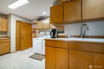 Utility with with backdoor down to the garage. Lots of cabinet space in here for pantry and desk if wanted.