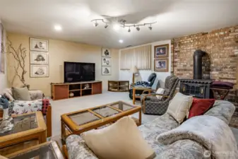 Another view of the family room with woodstove and carpet flooring.