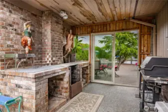 Exterior Barbeque room. The home has cedar siding and the next owner will get to pick their own colors as it will need painting.