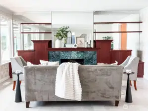 The front living room has a cozy fireplace and gorgeous custom built-in cabinetry