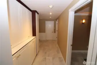 You won't believe the storage possibilities in this massive walk-in pantry with built-in cabinets and private garage access