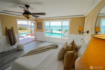 Epic views and romantic French doors await you from the large primary bedroom with a walk-in closet