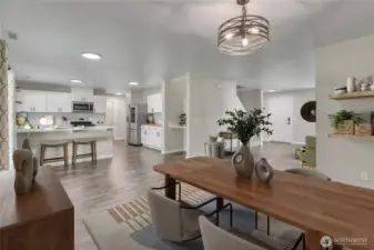 An open-concept design that blends dining, cooking, and relaxing all in one inviting space. Image is virtually staged.