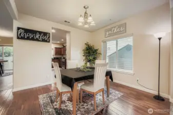 Spacious formal dining area with hardwood floors & rounded corners