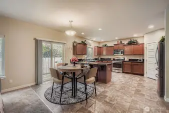 Great room concept combines kitchen, informal dining & living room to provide a welcoming environment for family & friends. The sliding glass door pictured here leads to your patio & hot tub (which stays!)