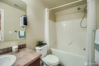 Main bathroom on the second floor with nice tub enclosure