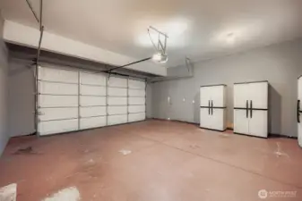 Fully finished, oversized 2 car garage with painted floor,  high ceilings, built-in storage organizers, updated water heater & an opener!