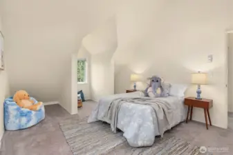 one of the two upstairs bedrooms. Note the sweet window overlooking the lush yard.