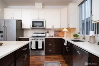 Spacious kitchen with ample cabinetry. Two finishes of cabinetry allow for the room to fell huge.  Upgraded countertop and appliances.