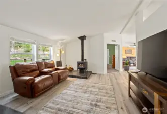 Living room just off of the entrance, wood burning stove heats the whole house