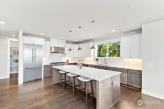 Gourmet kitchen features a large center island with eating bar.
