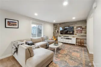 Cozy great room with custom rustic wood wall and recessed lighting with a dimmer