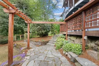 Flagstone patio and wood arbors.