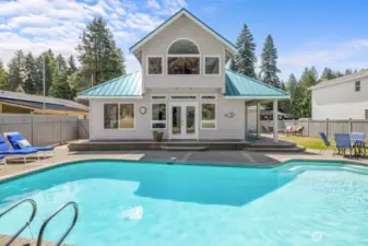 Summer is calling. Enjoy the pool while the golfers go by.