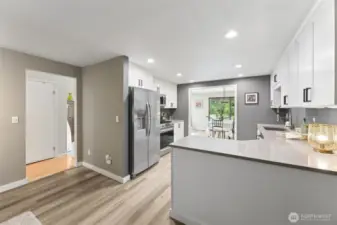 The kitchen is new, with LVP flooring, slate counter tops and plenty of storage space in the cabinets.