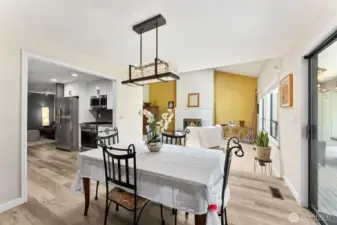 The dining room is next, with a very cool light fixture. The sliding doors on the right open onto the back deck.