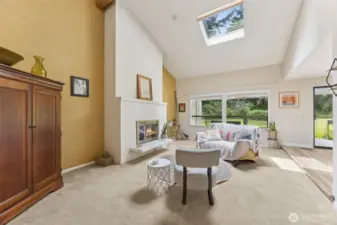 The sunkenliving room, soaring ceiling with skylights and the massive fireplace is a nod to mid-centry modern style.