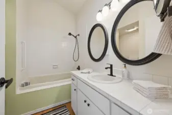 The primary bathroom has a tub/shower combination, and a step in shower to the left.
