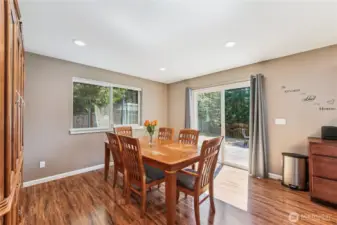 Dining area opens out to deck and expansive back yard