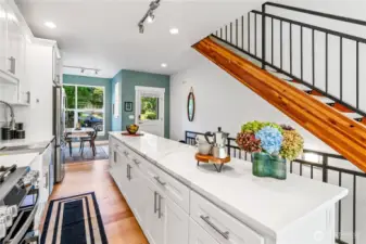 Looking towards the front door and dining area, you get a fantastic view of the wood-and-concrete staircase and the connectivity the kitchen has to the rest of the home.