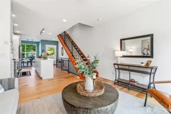 The sleek wood-and-concrete staircase anchors the space with architectural flair.