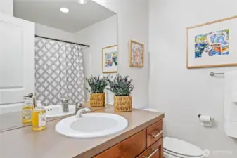 This daylight lower level has it all—whether you need a third bedroom, a quiet office, or just a place to retreat. Durable LVP flooring runs throughout (including on the stairs), leading to a practical full bath, laundry, and direct access to the back patio and garage.