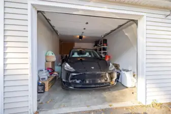The garage is spacious enough to fit a full-size car while still providing room for extra storage. It can also accommodate future upgrades like an electric vehicle charging station.