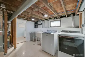 The utility area with deep sink and 1/2 bath to left.