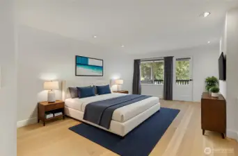 The primary main level bedroom has deck access, and on the right-hand side of the wall is access to hook up a wood-burning fireplace if desire.  All new light oak engineered hardwood and wall closets are on the right.