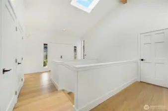 The front entry has three large closets, French doors to the main entrance, vaulted ceiling, new skylight, stairs to the daylight basement, and the door on the right leads to the three-car garage.