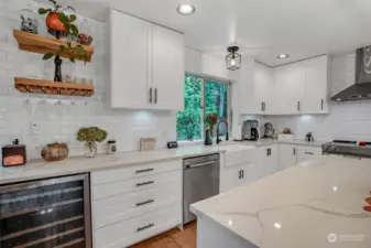 This kitchen comes equipped with a wine fridge and stainless appliances.