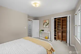 Primary bedroom with cedar lined closet and wood shuttters
