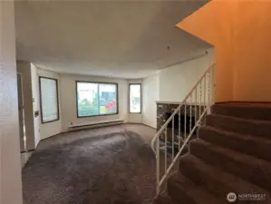 Living room with large front windows.